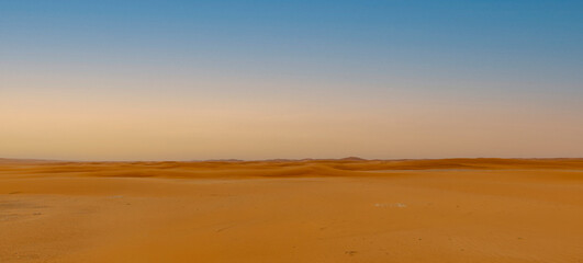 Fototapeta na wymiar Middle East orange sand dunes desert panorama 