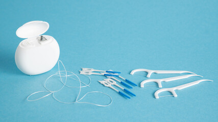 Set of home dental cleaning tools. Floss in white container, dental floss picks, toothpicks sticks, interdental brushes