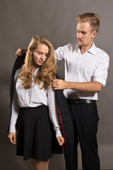 Young man giving his jacket to his girl