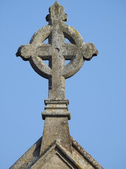 Stone cross on the roof of the church