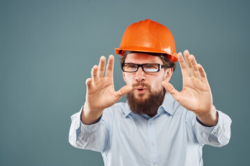 emotional man wearing glasses orange helmet work industry