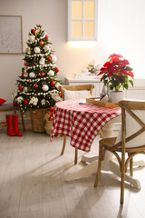 Beautiful kitchen interior with Christmas tree and festive decor