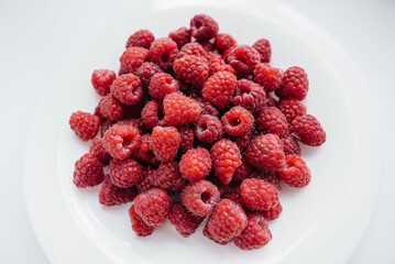 Red raspberry berries close-up on a white background. Healthy food, natural vitamins. Fresh berries