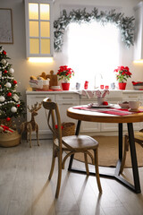 Beautiful kitchen interior with Christmas tree and festive decor