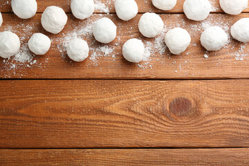 Snowballs on wooden background, flat lay. Space for text