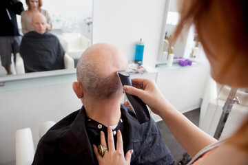 Man getting his head shaved in salon