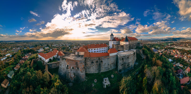 Aerial view of medieval castle on mountain in small european city in autumn season