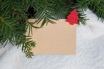 Christmas craft holiday card in the tree branches. Top view. Place for inscription. Advertising