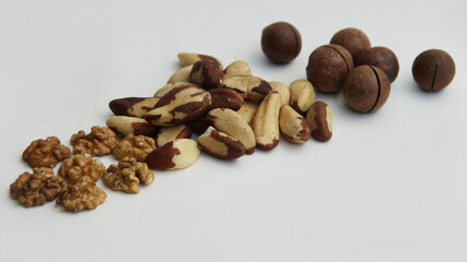 walnuts, macadamia, and Brazil nuts on a white background