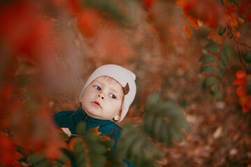 The happy child is coming. A boy dressed in a green jacket and brown trousers.