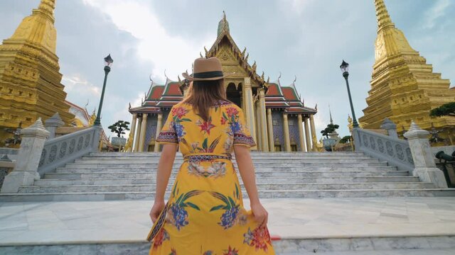 Asian woman visiting Wat Phra Kaew or Emerald buddha temple in Bangkok Thailand