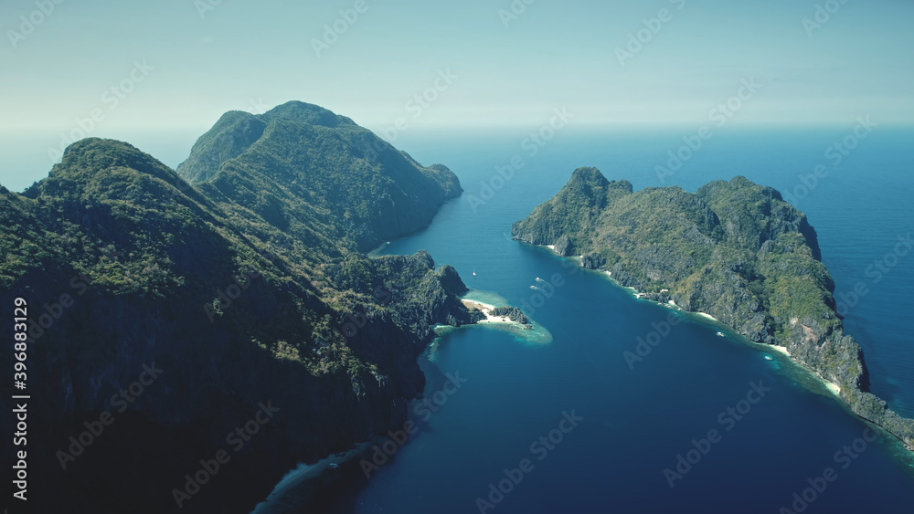 Wall mural sail boats, yacht at ocean bay of dark green mount island aerial view. water transport at tropical g