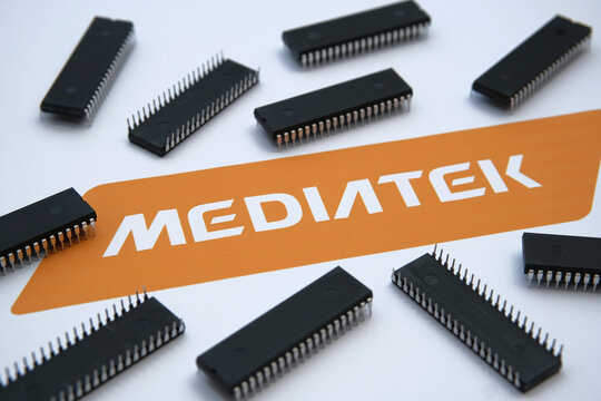 Stone / United Kingdom - July 23, 2020: Mediatek semiconductor chip manufacturer company logo seen on the paper and microchips placed around. Selective focus.