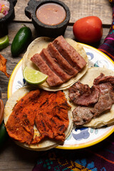 Assortment of mexican tacos on wooden background