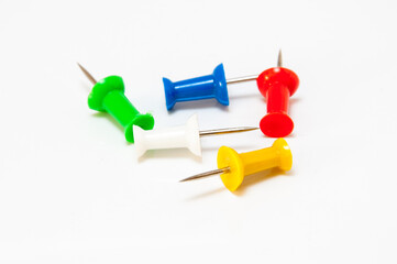 Pins in different colors, collection of various pushpins on white background