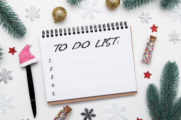 To-do list in a spiral notepad on a desk with flat lay winter decor