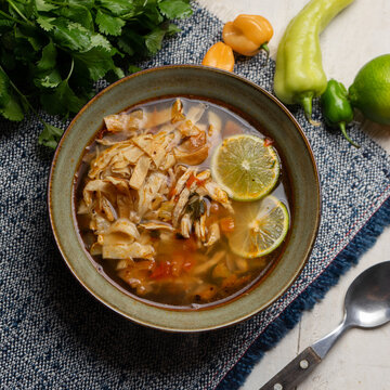 Mexican lime soup with chicken on white background