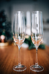 Champagne glasses on the table against the background of the Christmas tree