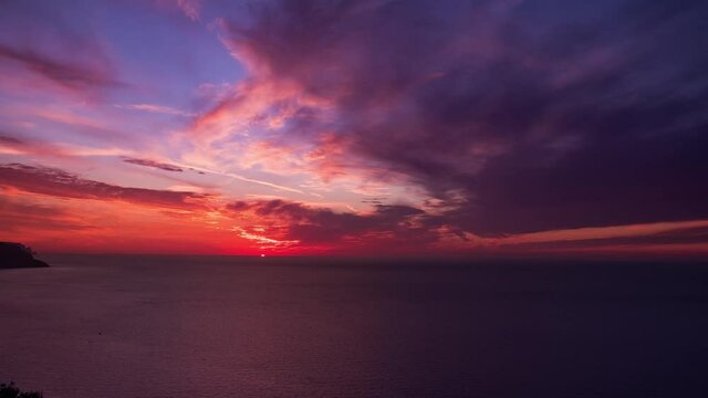 spectacular sunset hyperlapse on the sea with cloudy twilight sky and cliffs coastline. timelapse of sunset from sa foradada viewpoint in mallorca island with epic panorama