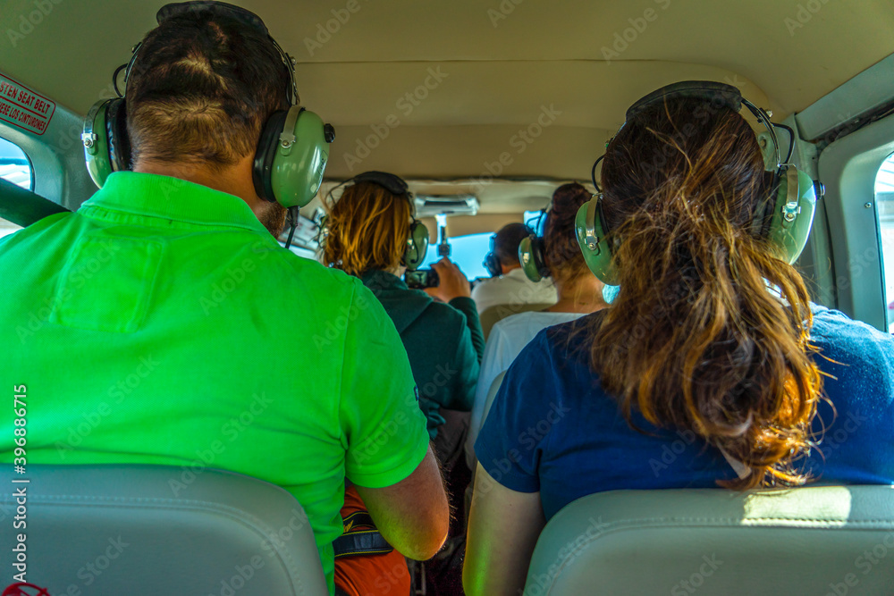 Wall mural peru, nazca, tourist passengers inside a small sightseeing plane.