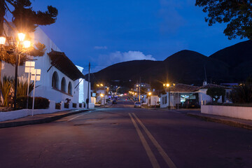 Colombian colonial town at evening blue hour with city lights and empty street