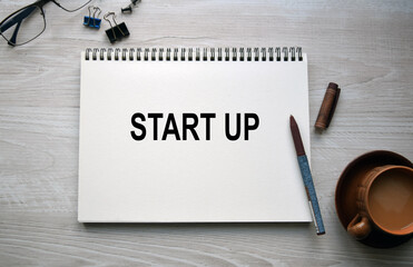 notebook with a conceptual inscription and a cup of coffee on a table