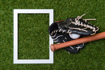 Baseball bat, glove and ball on green grass field.  Sport theme background with copy space for text and advertisment