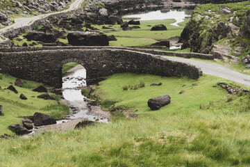Scenic view of Gap of Dunloe, County Kerry, Ireland.. The River Loe and narrow mountain pass road wind through the steep valley, nestled in the Macgillycuddy's Reeks mountains. The Ring of Kerry Route
