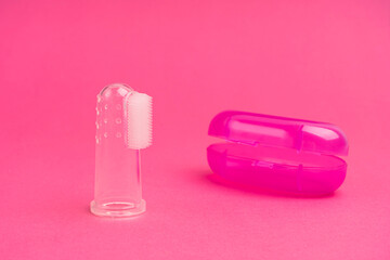 Compact toothbrush fingertip. Travel hygiene close up