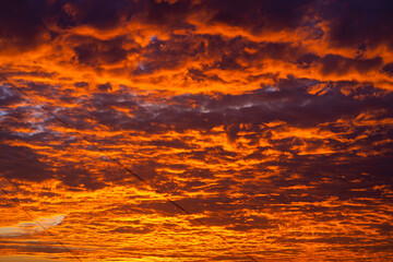 Fototapeta na wymiar The colors of a burning sunset in the sky