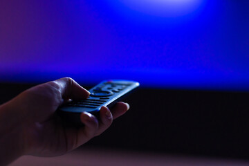 leisure at home. Watch TV. Remote control in hand close-up