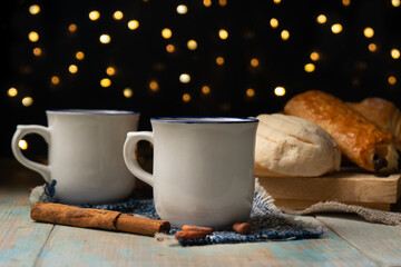Hot cocoa with cinnamon and bread  on dark background
