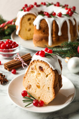 Composition with piece of traditional homemade Christmas cake on white marble table, closeup