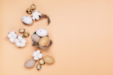 Easter eggs on beige pastel background with space for text. Flat lay image composition, top view.