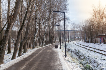 An old abandoned railway on the outskirts of the city covered with snow. Railway signs.