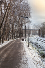 An old abandoned railway on the outskirts of the city covered with snow. Railway signs.