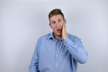 Business young man wearing a casual shirt over white background touching mouth with hand with painful expression because of toothache or dental illness on teeth