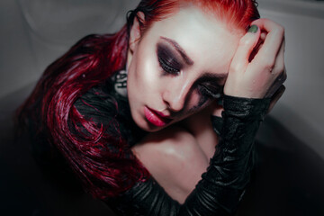 
Girl with red hair and black handprints on her face 