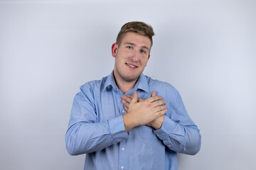 Business young man wearing a casual shirt over white background smiling with her hands on her chest and grateful gesture on her face.