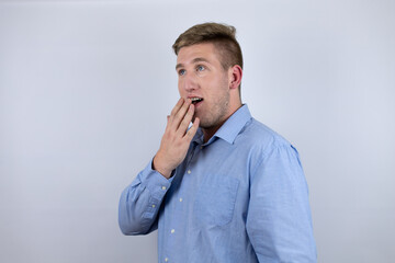 Business young man wearing a casual shirt over white background surprised, covering his mouth with hands