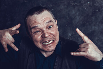 Middle aged social marginal emotional studio portrait.