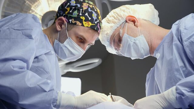 Surgeons do plastic operation in medical clinic. Surgery. Professional medecine. Skin care. Correcting form of face for patient