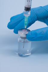 Concept fight against virus covid-19 corona virus, scientist in laboratory holding a syringe with liquid vaccines for children or older adults