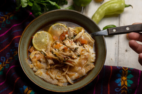 Mexican lime soup with chicken on white background