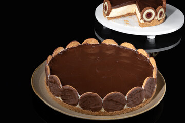  hollandaise pie covered with chocolate ganache on a reflective dark background