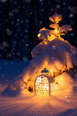 Christmas lantern under a Christmas tree in a snowy forest