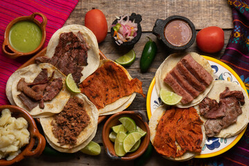 Assortment of mexican tacos on wooden background