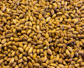 Closeup of Pistachios in shell. Pistachio textured background. Pistachios on market.