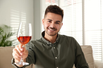 Man drinking wine while having online video conference at home, view from web camera. Social distancing during coronavirus pandemic