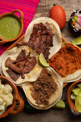 Assortment of mexican tacos on wooden background